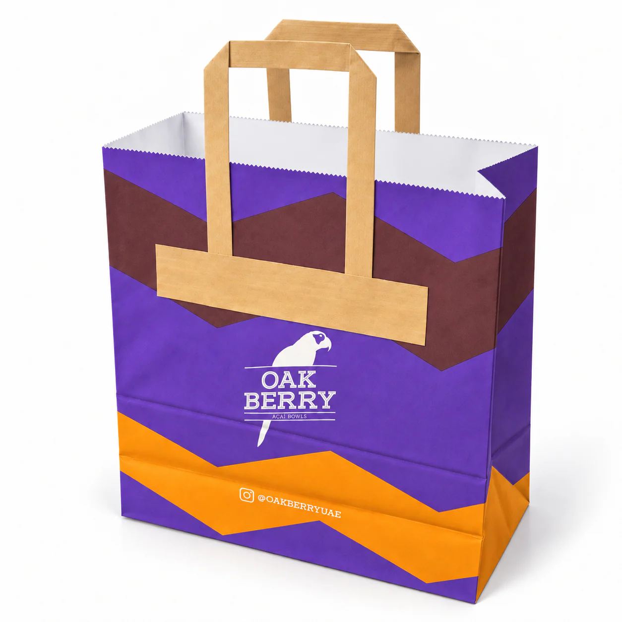Purple bag with tan flat paper handles, an exterior attachment patch and orange and burgundy geometric printing.