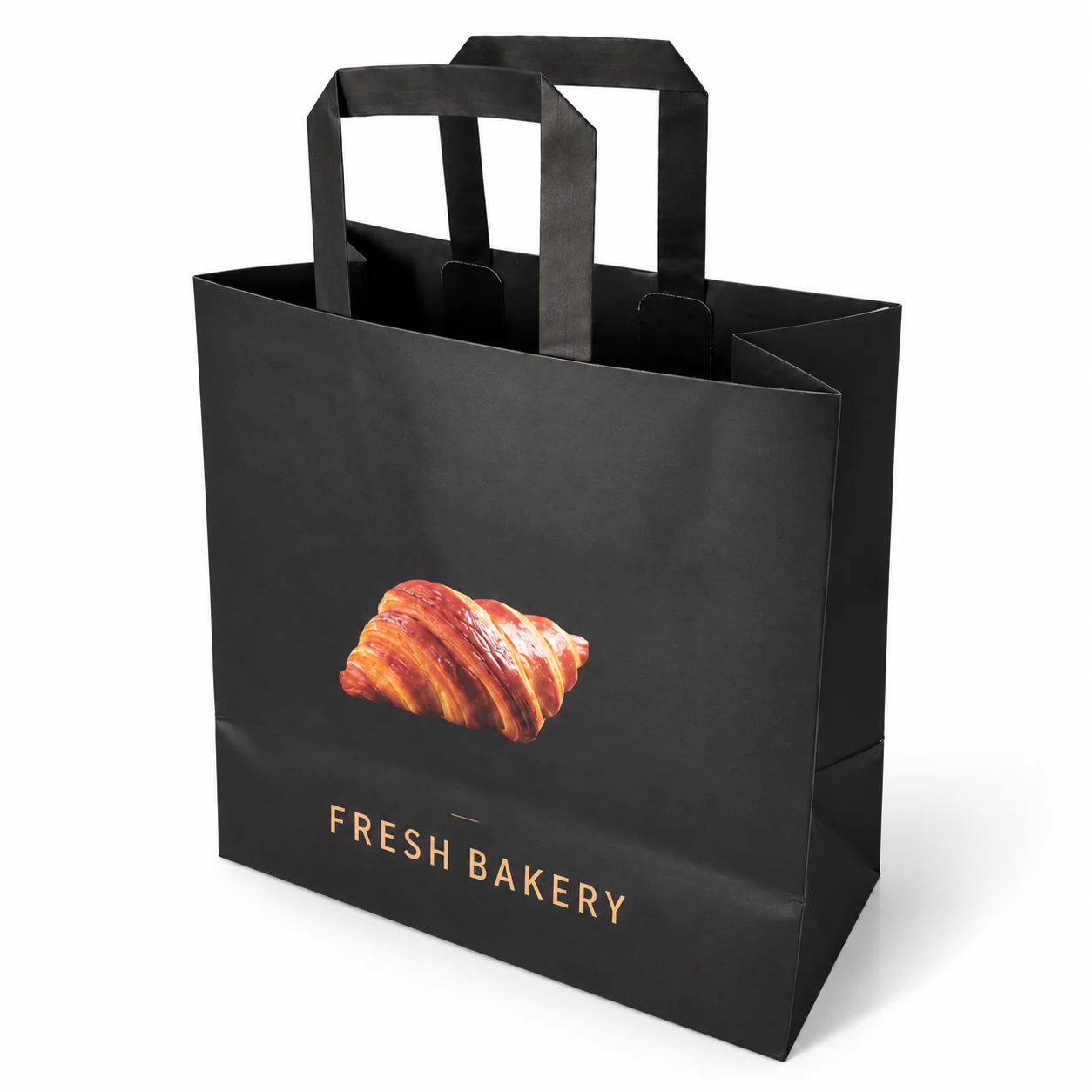 Black bag with matching flat paper handles, a croissant image and gold-coloured bakery lettering.