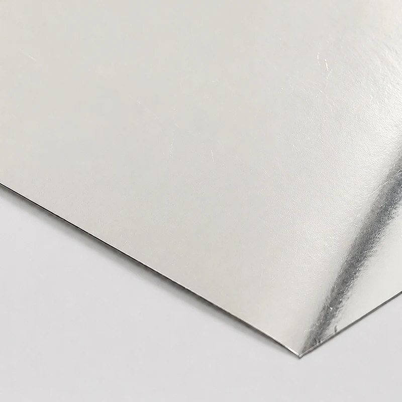 Metallic Silver Paper Close-up of a reflective silver paper sheet and its corner.