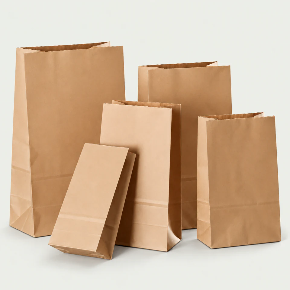 Five handleless brown kraft paper bags in different widths and heights.