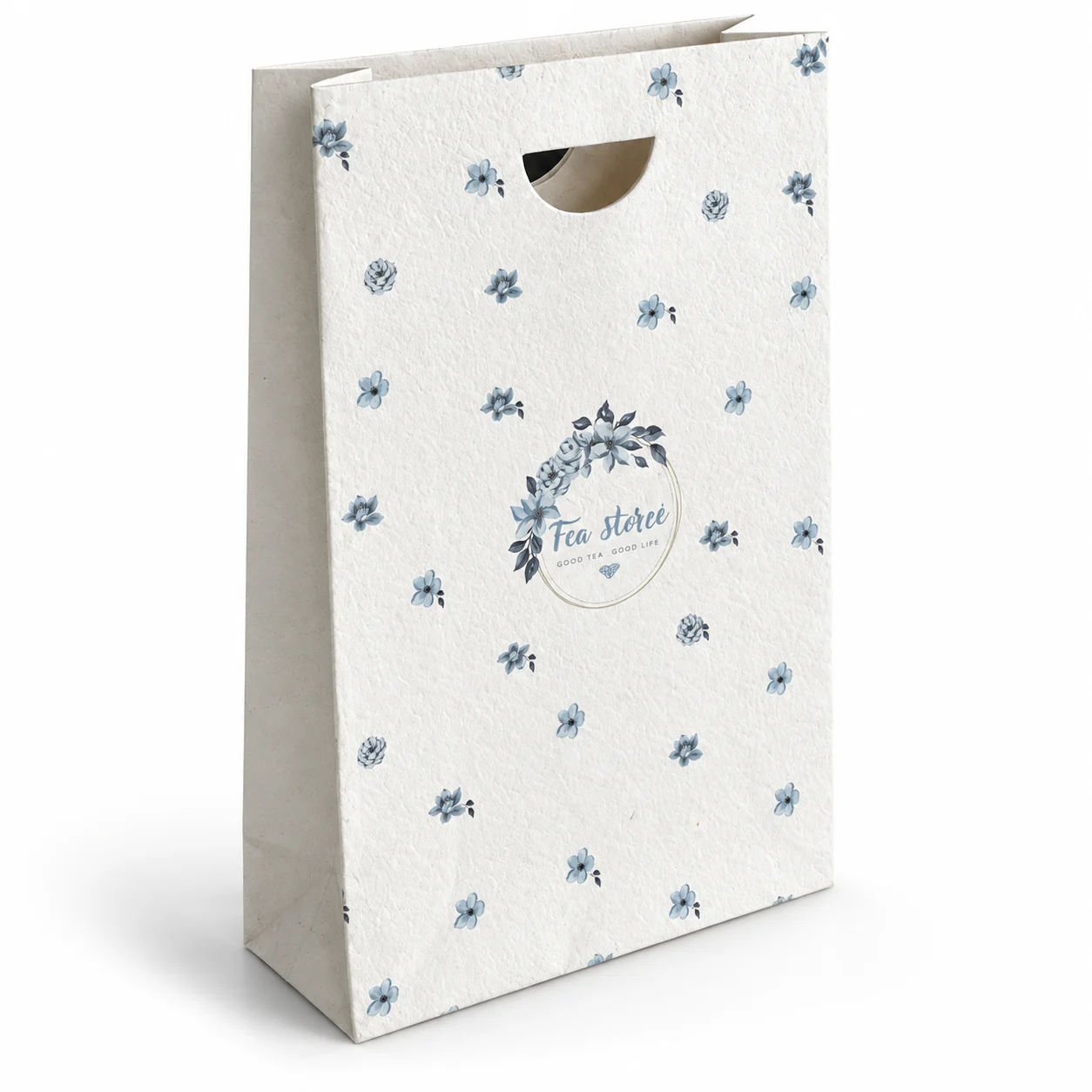 Tall cream paper bag with blue floral printing and a half-round die-cut handle.