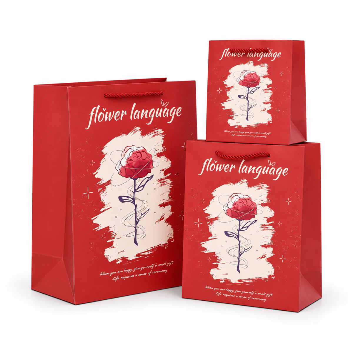 Red rose print paper bags Three red paper bags with rope handles, rose illustrations and pale brushstroke backgrounds.