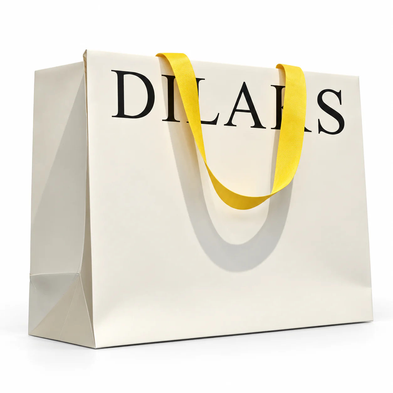 Three-quarter view of a cream paper bag with bright yellow ribbon handles folded over the top edge.