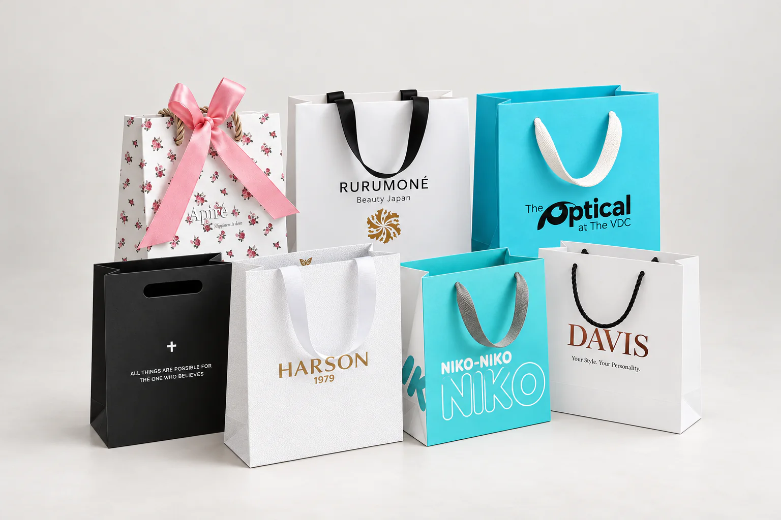A group of custom shopping bags in assorted sizes, colours and handle styles.