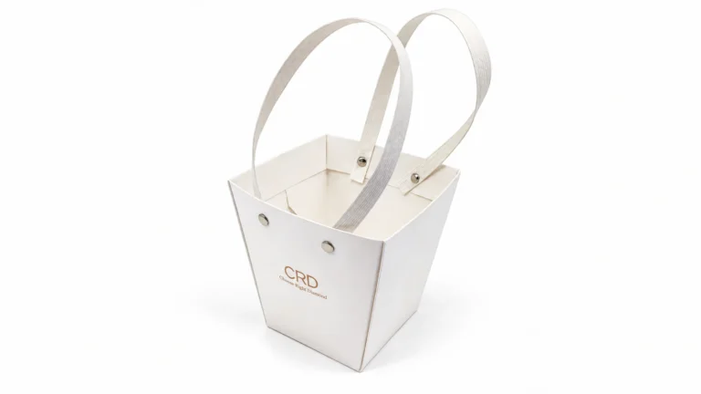 White tapered CRD paper bag with two pale textured strap handles and visible round rivets, viewed from above on a white background