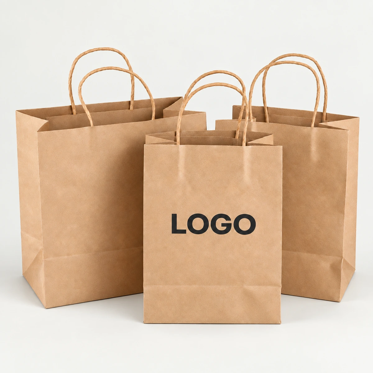 Three brown paper bags with twisted handles, including a smaller bag with a printed logo