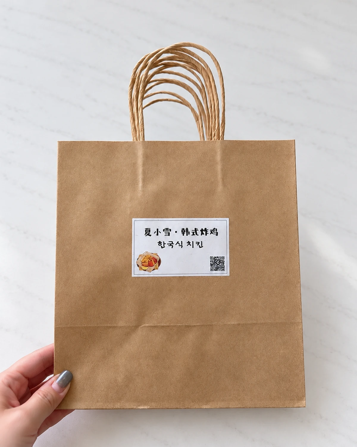 Stack of brown kraft bags with paper-cord handles and white rectangular printed labels