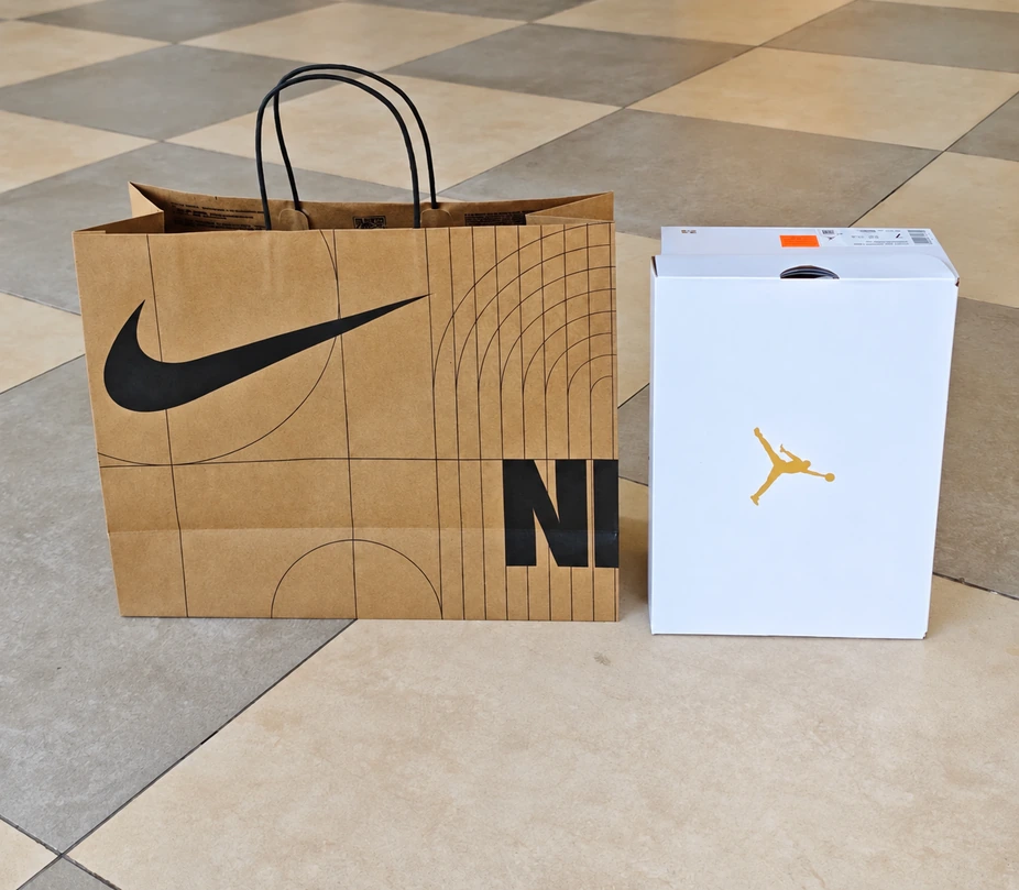 Medium wide Nike kraft paper bag beside the white reference shoebox