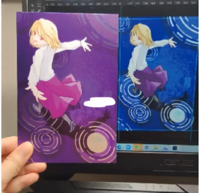 A purple printed illustration held beside a blue-looking version on a laptop screen