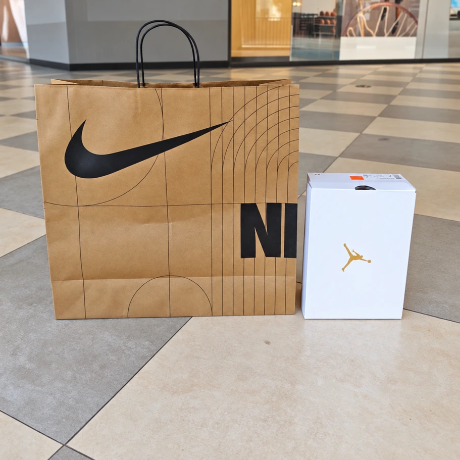 Tall extra-large Nike kraft paper bag beside the white reference shoebox