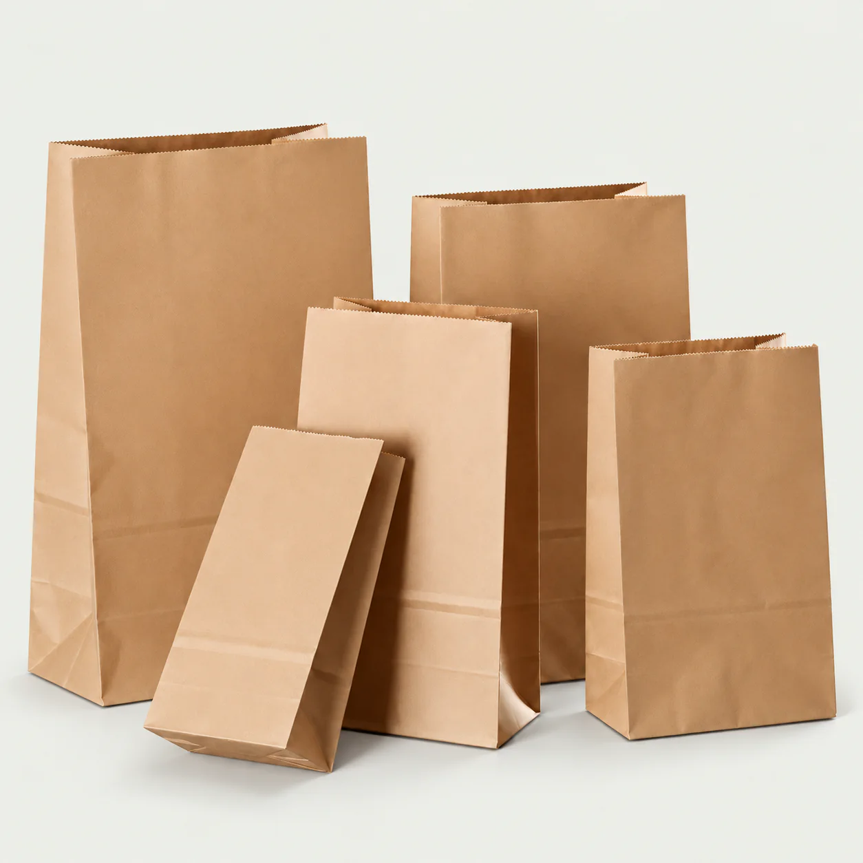 Handleless natural kraft paper bags in several sizes.